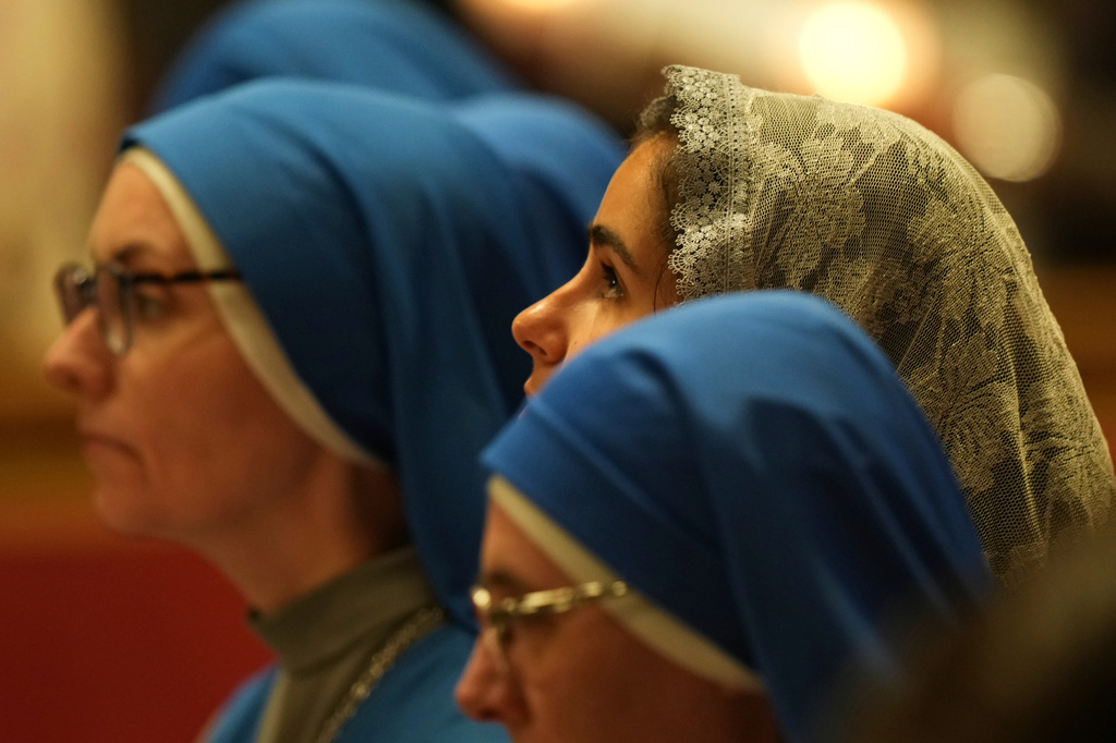 A faithful attends Pope Leo XIV's Easter Vigil inside St. Peter's Basilica at The Vatican, Saturday, April 4, 2026. (AP Photo/Andrew Medichini)