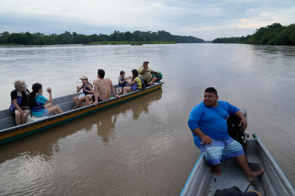 Carlos Diaz, a fisherman and tour guide, steers a tourist boat on a “hippo-watching” outing along the Magdalena River in Puerto Triunfo, Colombia, Wednesday, April 22, 2026. (AP Photo/Fernando Vergara)