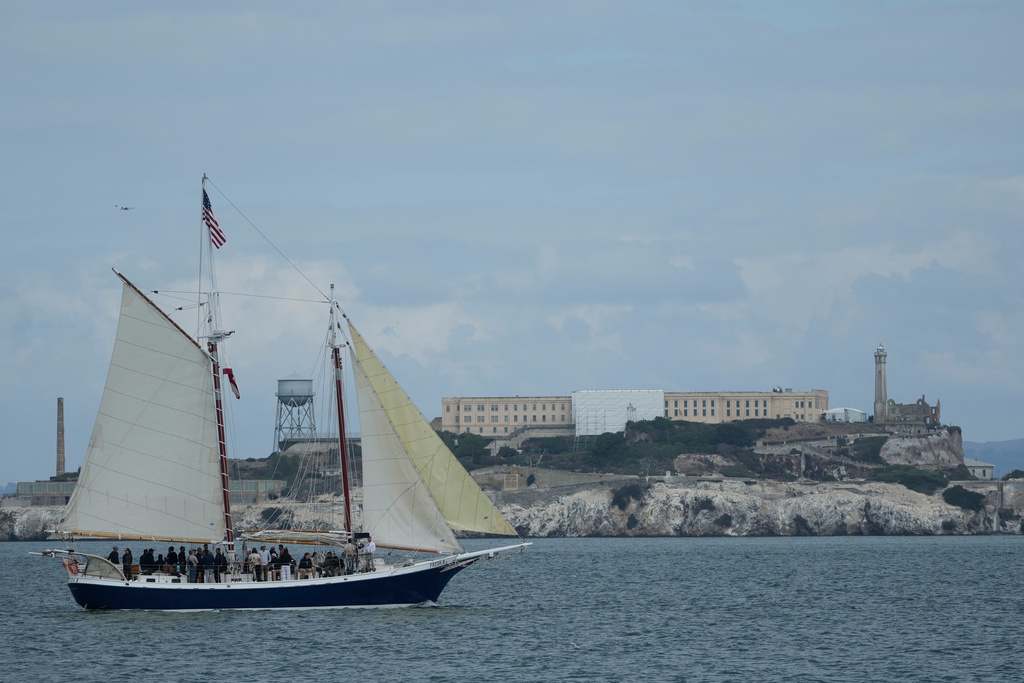 A boat sails in front of Alcatraz Island in San Francisco, Friday, Oct. 10, 2025. (AP Photo/Jeff Chiu)