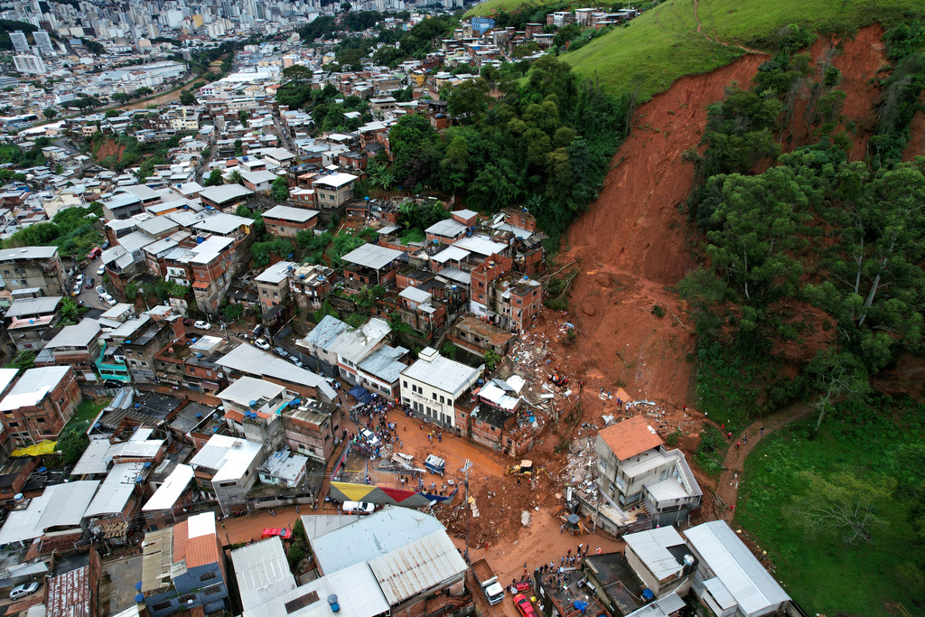 Collapsed homes sit after heavy rains and severe flooding in the Parque Burnier neighborhood of Juiz de Fora in Minas Gerais state, Brazil, Tuesday, Feb. 24, 2026. (AP Photo/Silvia Izquierdo)