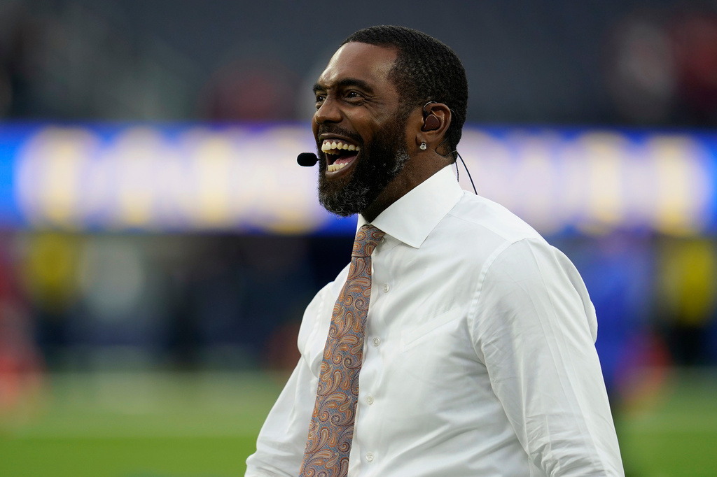 FILE - Former wide receiver and TV analyst Randy Moss walks on the field before an NFL wild-card playoff football game between the Los Angeles Rams and the Arizona Cardinals in Inglewood, Calif., Monday, Jan. 17, 2022. (AP Photo/Marcio Jose Sanchez, File)