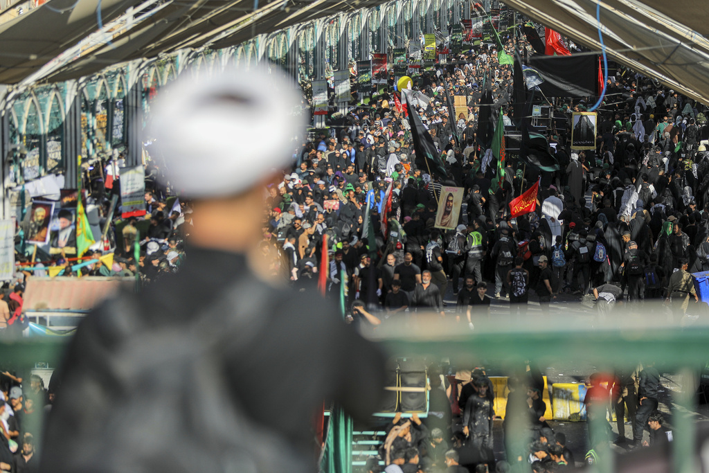 Shiite pilgrims participate in Arbaeen, which marks the end of the 40-day mourning period following Ashoura, in Karbala, Iraq, Thursday, Aug. 14, 2025. (AP Photo/Ammar Khalil)