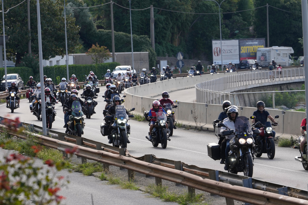 Guzzi bikers run during the Grand Parade along the route from Lecco to Mandello del Lario on Lake Como, part of the Moto Guzzi World Days 2026, as the maker celebrates its 105th anniversary, in Lecco, Italy, Saturday, Sept. 5, 2026. (AP Photo/Luca Bruno)