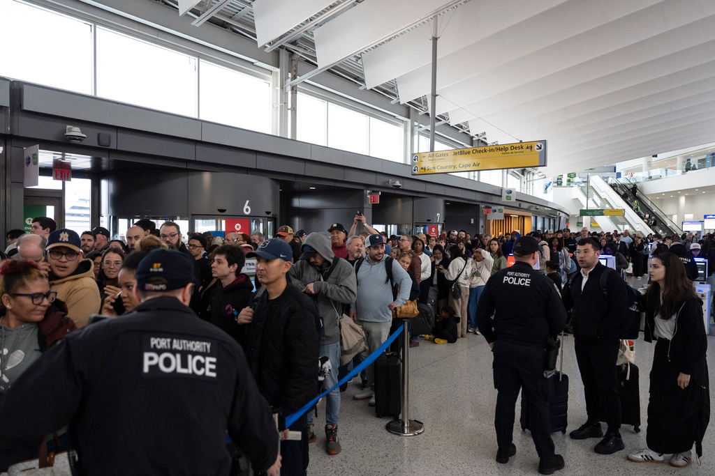 People wait in a TSA line at the John F. Kennedy International Airport, Sunday, March 22, 2026, in New York. (AP Photo/Yuki Iwamura)