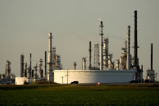 FILE - A motorist drives past the CHS oil refinery Sept. 28, 2024, in McPherson, Kan. (AP Photo/Charlie Riedel, File) FILE - A motorist drives past the CHS oil refinery Sept. 28, 2024, in McPherson, Kan. (AP Photo/Charlie Riedel, File)