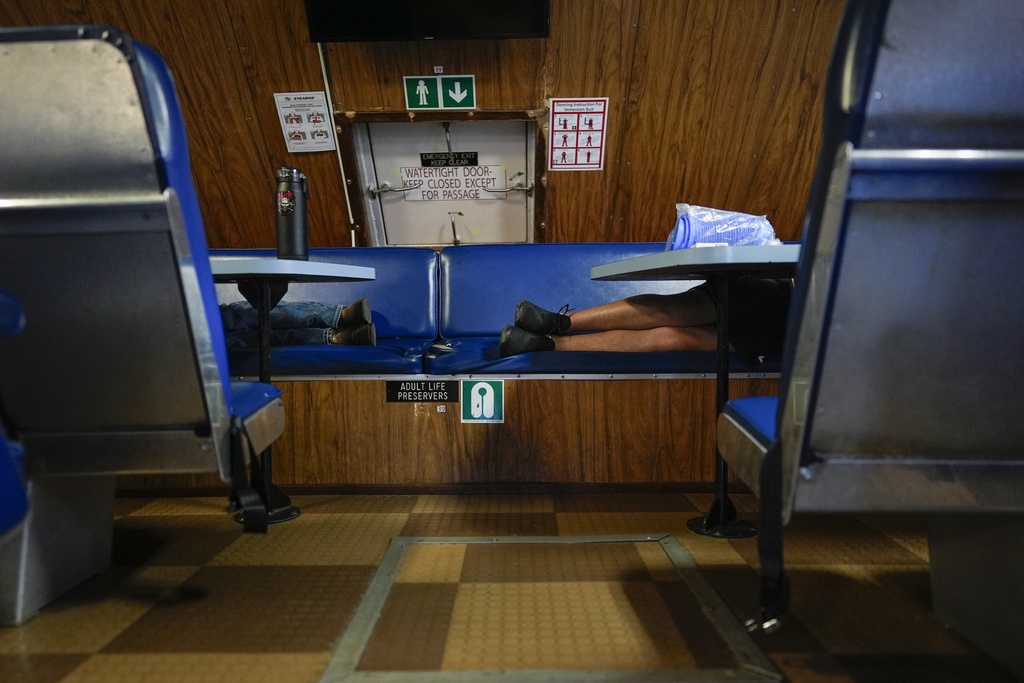 Expedition 501 members sleep on the Gaspee, a crew transport vessel, after leaving port in Fall River, Mass., during the eight-hour trip to the Liftboat Robert platform in the North Atlantic, Saturday, July 19, 2025. (AP Photo/Carolyn Kaster)