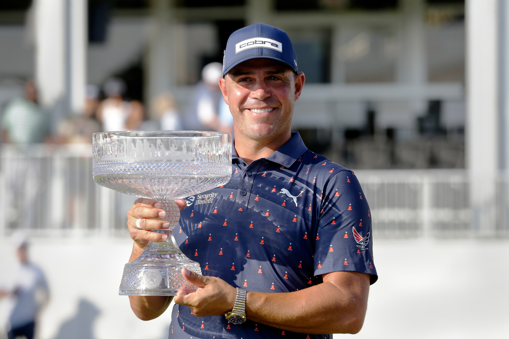 Gary Woodland holds the championship trophy after winning the Texas Children's Houston Open golf tournament Sunday, March 29, 2026, in Houston. (AP Photo/Michael Wyke)