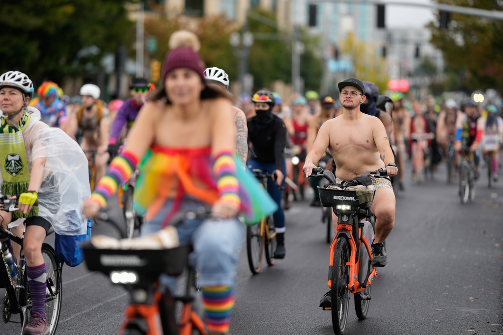 People participate in the Naked Bike Ride protest on Sunday, Oct. 12, 2025, in Portland, Ore. (AP Photo/Jenny Kane)