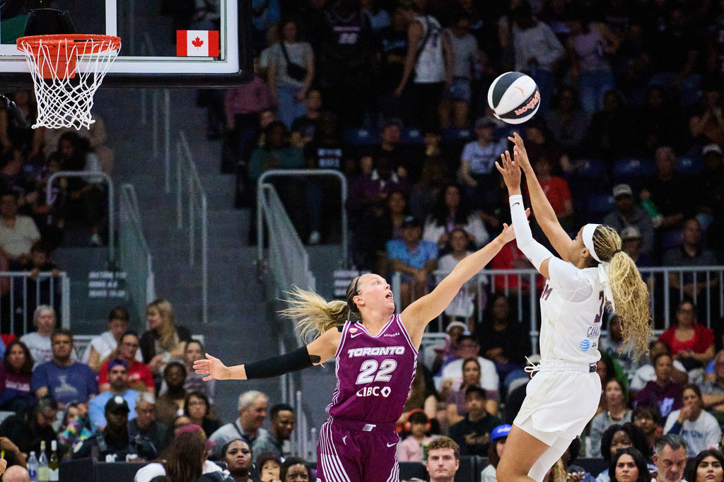 Atlanta Dream's Jordin Canada, right, shoots over Toronto Tempo's Julie Allemand (22) during the first half of a WNBA basketball game in Toronto, Sunday, June 14, 2026. (Sammy Kogan/The Canadian Press via AP)