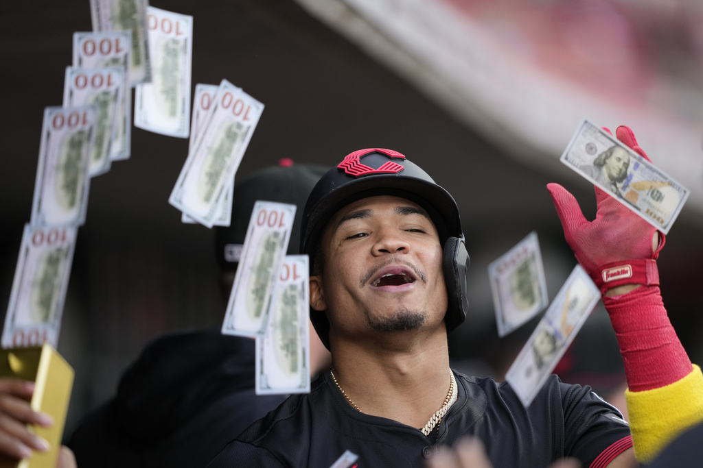 Cincinnati Reds' Noelvi Marte celebrates in the dugout after hitting a solo home run during the first inning of a baseball game against the St. Louis Cardinals Friday, Aug. 29, 2025, in Cincinnati. (AP Photo/Carolyn Kaster)