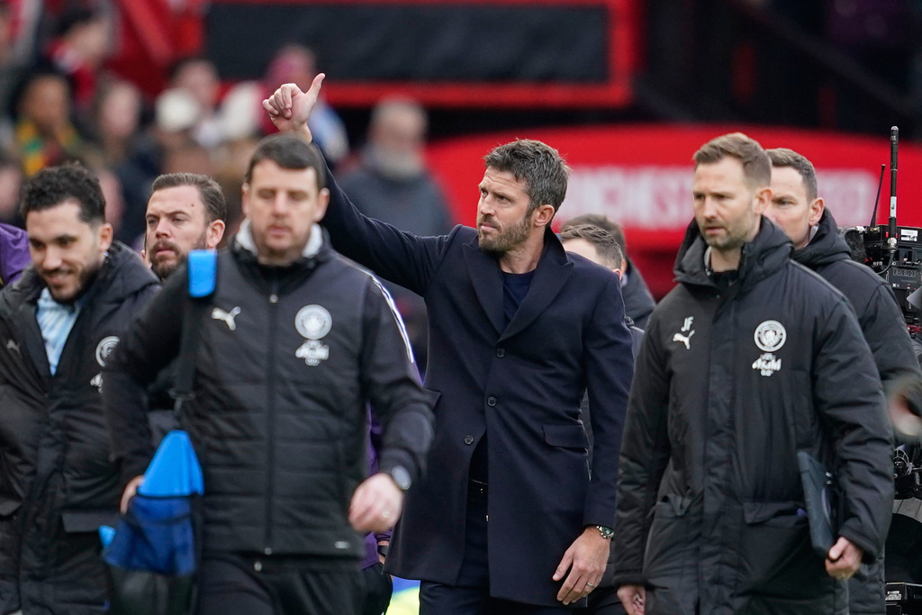 Manchester United's head coach Michael Carrick, centre, arrives ahead of the English Premier League soccer match between Manchester United and Manchester City in Manchester, England, Saturday, Jan. 17, 2026. (AP Photo/Dave Thompson)