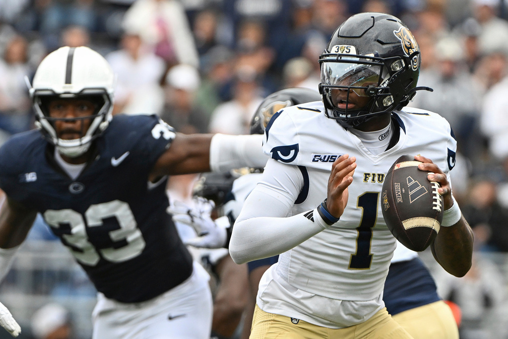 Florida International quarterback Keyone Jenkins (1) looks to pass while being pressured by Penn State defensive end Dani Dennis-Sutton (33) during the first quarter of an NCAA college football game, Saturday, Sept. 6, 2025, in State College, Pa. (AP Photo/Barry Reeger)