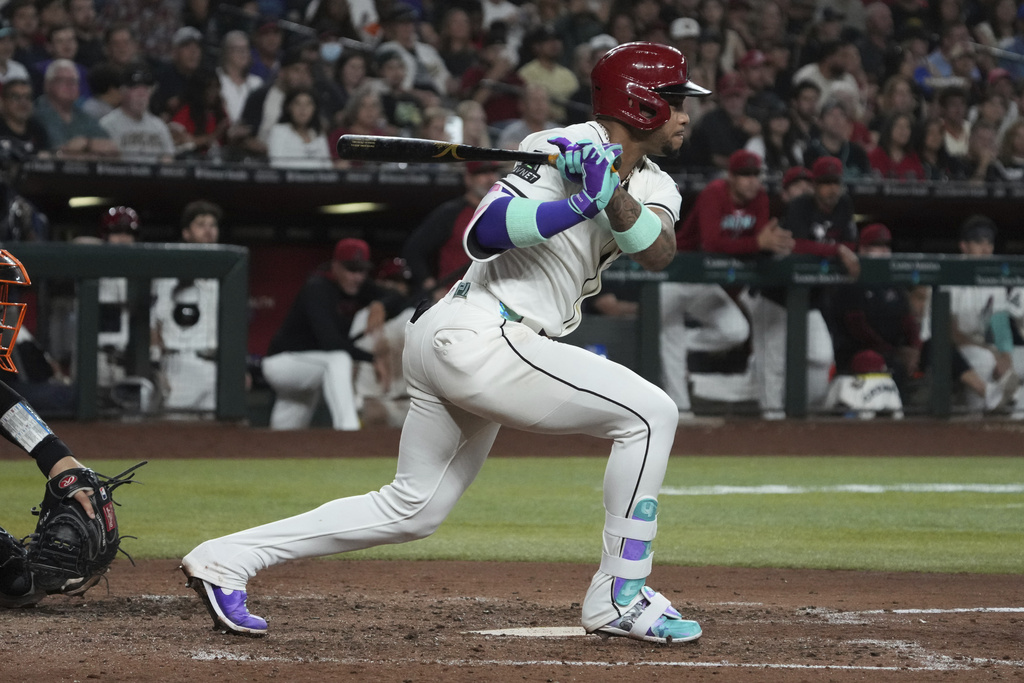 Arizona Diamondbacks' Ketel Marte hits an RBI single against the San Francisco Giants in the fifth inning of a baseball game, Tuesday, Sept. 16, 2025, in Phoenix. (AP Photo/Rick Scuteri)