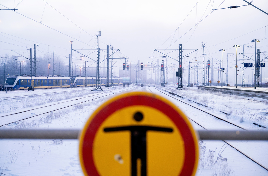 A NordWestBahn train stands on a track at the main station in freezing temperatures, in Oldenburg, Germany, Sunday, Jan. 11, 2026. (Hauke-Christian Dittrich/dpa via AP)