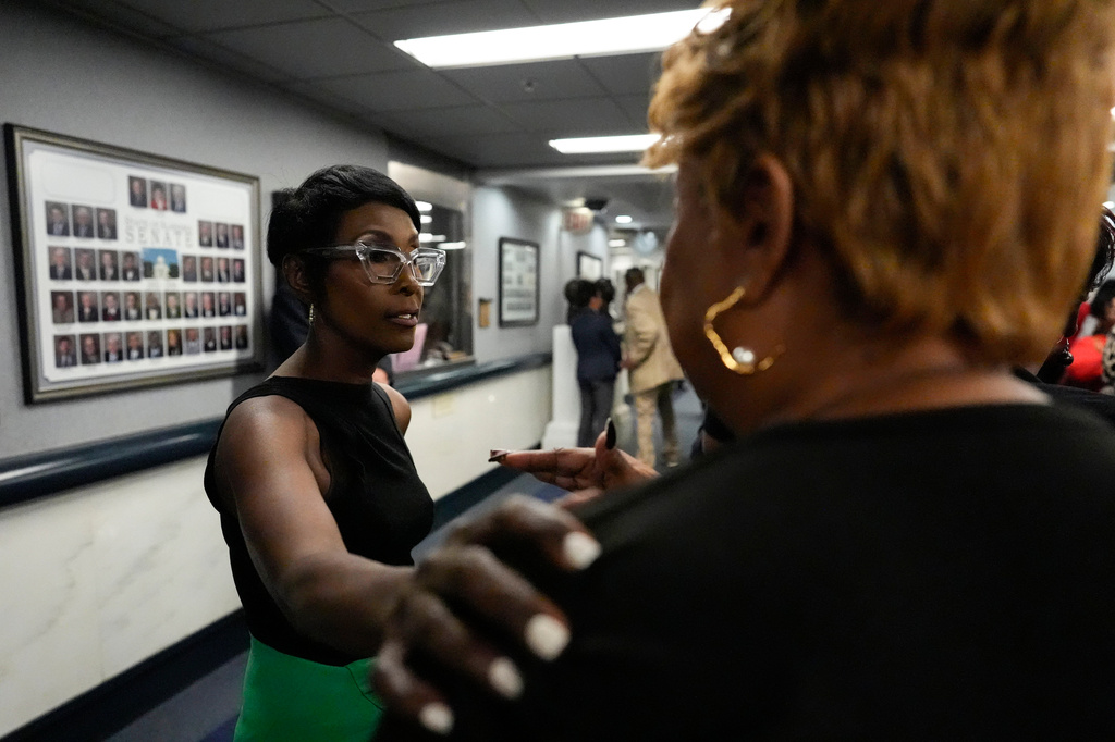 Democrat Alabama State Rep. Juandalynn Givan speaks with a demonstrator as they protest in the Senate hallway in response to HB1 and SB1, redistricting bills, during a special session of the Alabama Legislature, Wednesday, May 6, 2026, in Montgomery, Ala. (AP Photo/Mike Stewart)