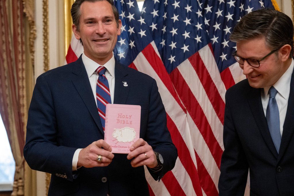 Rep. Matt Van Epps, R-Tenn, left, holds his daughter's bible he used to take the oath of office before the start of a ceremonial swearing-in with Speaker Mike Johnson, R-La., Thursday, Dec. 4, 2025, in Washington. (AP Photo/Kevin Wolf)