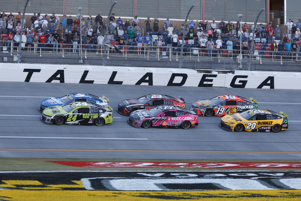 William Byron (24) and Kyle Larson (5) lead the pack during a NASCAR Cup Series auto race at Talladega Superspeedway, Sunday, Oct. 19, 2025, in Talladega, Ala. (AP Photo/Butch Dill)