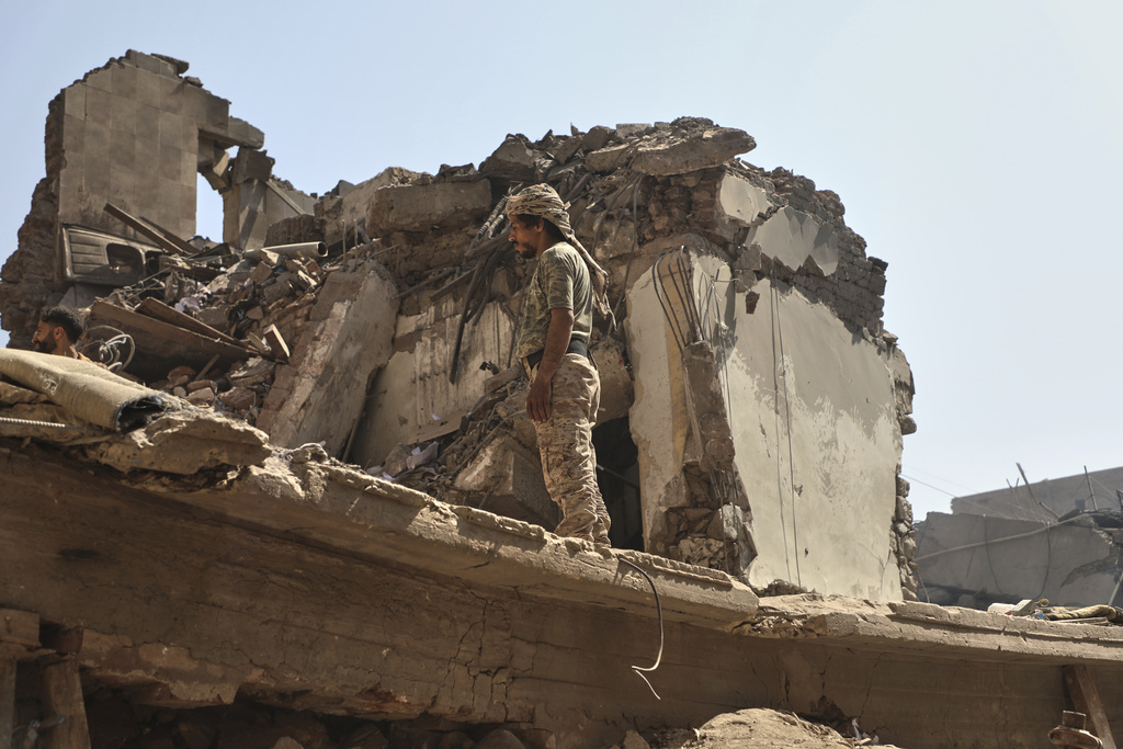 A Yemeni man inspects a building destroyed in Wednesday's Israeli airstrikes in Sanaa, Yemen, Saturday, Sept. 13, 2025. (AP Photo/Osamah Abdulrahman)