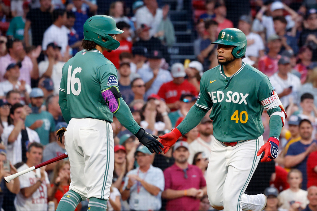 Boston Red Sox's Willson Contreras (40) is congratulated by teammate Jarren Duran (16) after hitting a solo home run during the third inning of a baseball game against the New York Yankees, Friday, June 26, 2026, in Boston. (AP Photo/Mary Schwalm)