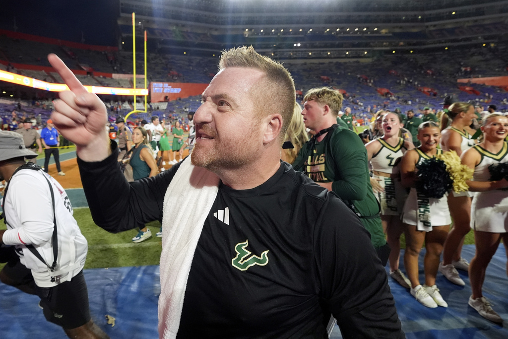 South Florida head coach Alex Golesh points to fans as he leaves the field as he celebrates defeating Florida in an NCAA college football game, Saturday, Sept. 6, 2025, in Gainesville, Fla. (AP Photo/John Raoux)