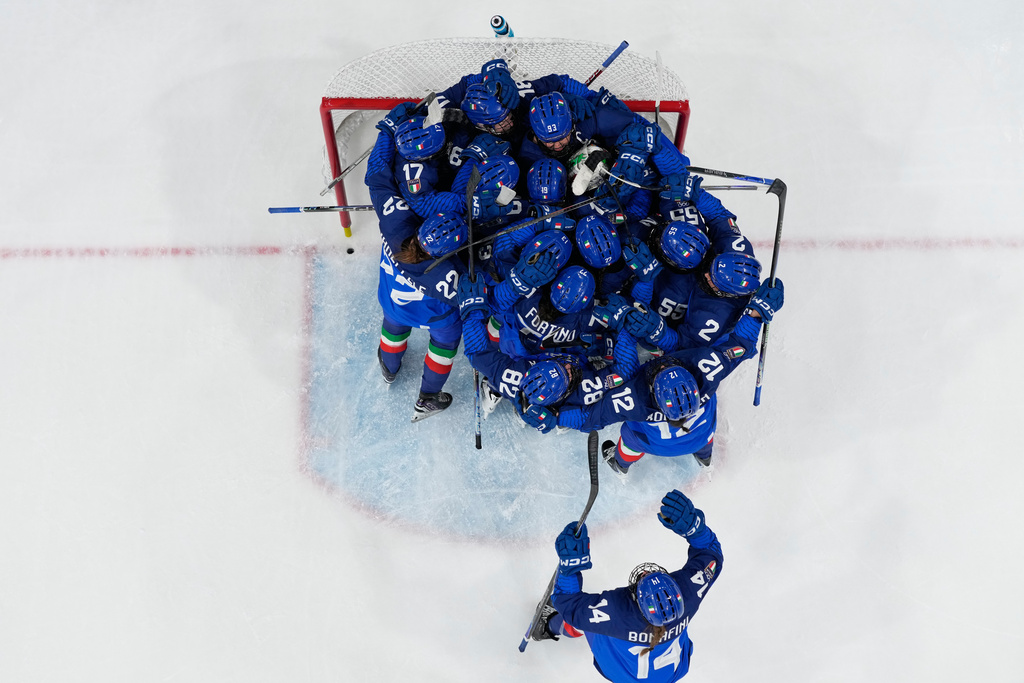 Italy players celebrate end of a preliminary round match of women's ice hockey between Japan and Italy at the 2026 Winter Olympics, in Milan, Italy, Monday, Feb. 9, 2026. (AP Photo/Hassan Ammar)