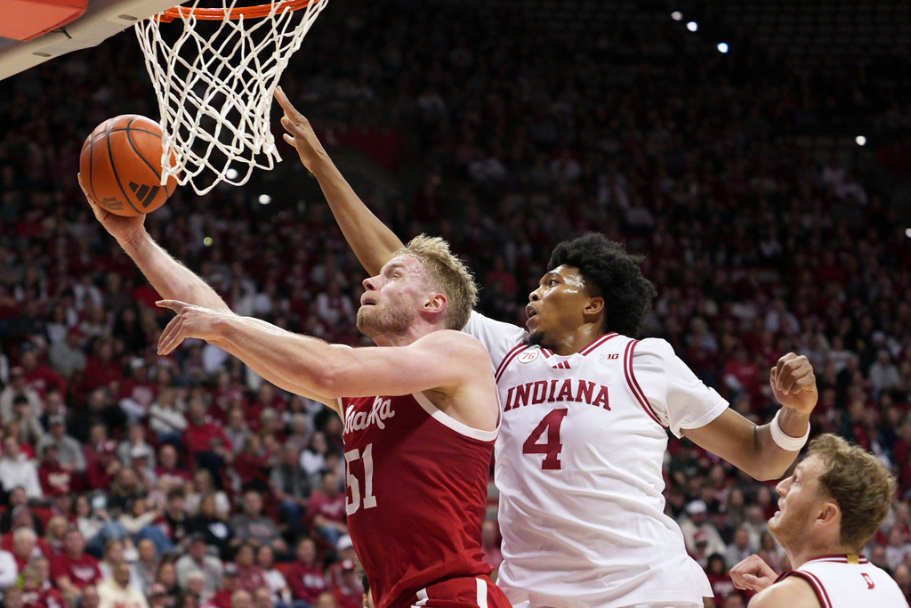 Nebraska forward Rienk Mast (51) shoots under the defense of Indiana forward Sam Alexis (4) during the first half of an NCAA college basketball game in Bloomington, Ind., Saturday, Jan. 10, 2026. (AP Photo/AJ Mast)