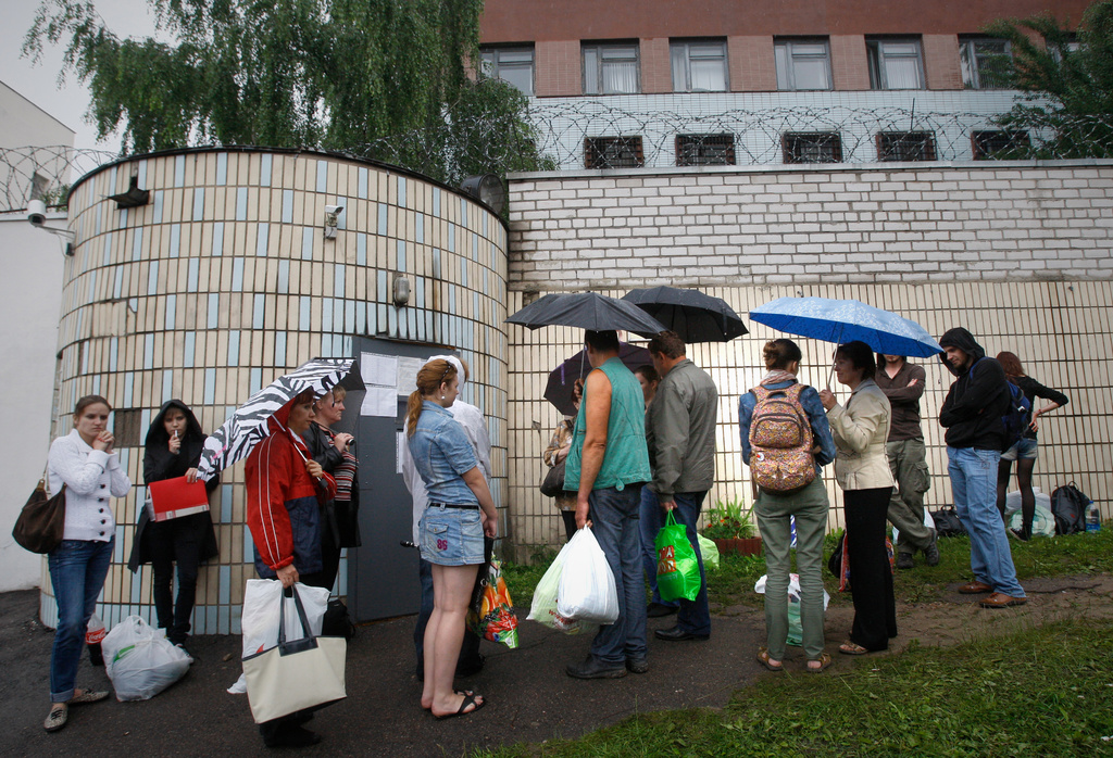 FILE - Relatives and friends of arrested participants of the flash mob "Revolution through a social network" wait outside the prison walls to bring food and clothes near a detention centre in Minsk, Belarus, Thursday, July 7, 2011. (AP Photo, File)