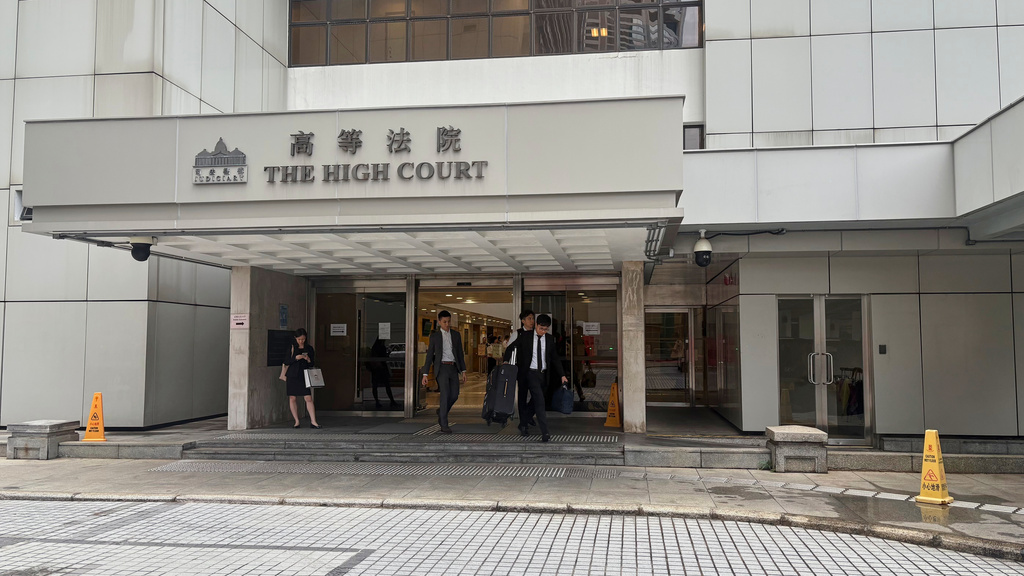People walk out of the Hong Kong High Court in Admiralty, Hong Kong, on Tuesday, Sept. 9, 2025. (AP photo/Kanis Leung)