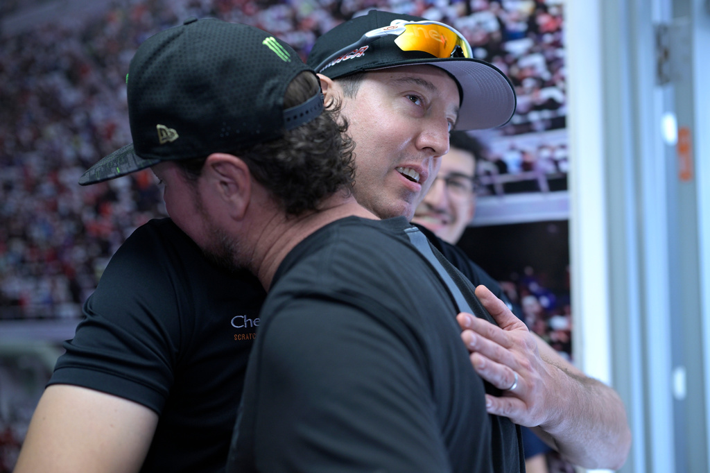 FILE - Kurt Busch, front, gets a hug from his brother, Kyle Busch, after announcing his retirement before a NASCAR Cup Series auto race at Daytona International Speedway, Aug. 26, 2023, in Daytona Beach, Fla. (AP Photo/Phelan M. Ebenhack, File)