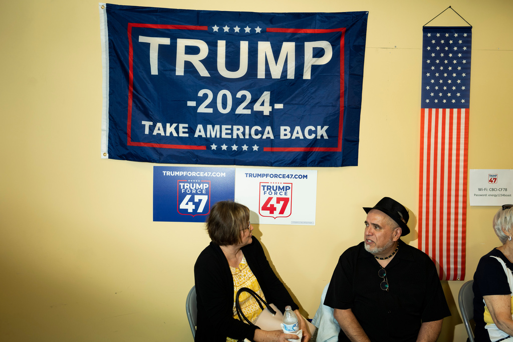 FILE - Attendees gather as the "Latino Americans for Trump" office opens in Reading, Pa., Wednesday, June 12, 2024. (AP Photo/Joe Lamberti)