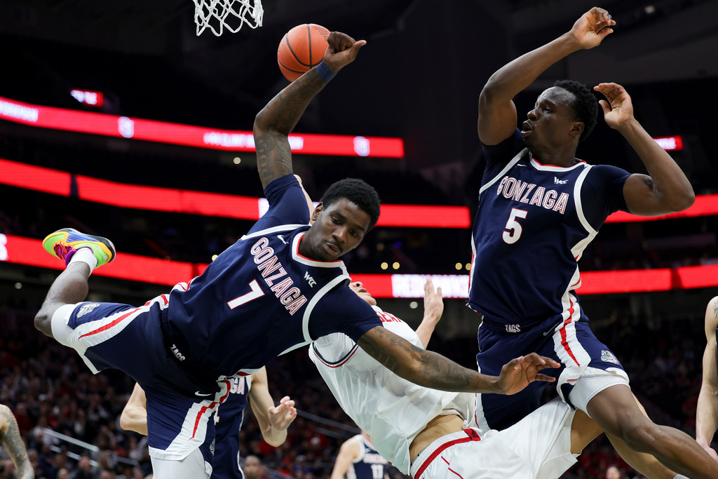 Gonzaga guard Tyon Grant-Foster, left, and forward Emmanuel Innocenti, right, collide with Seattle University center Houran Dan, center, during the second half of an NCAA college basketball game Saturday, Jan. 17, 2026, in Seattle. (AP Photo/Ryan Sun)