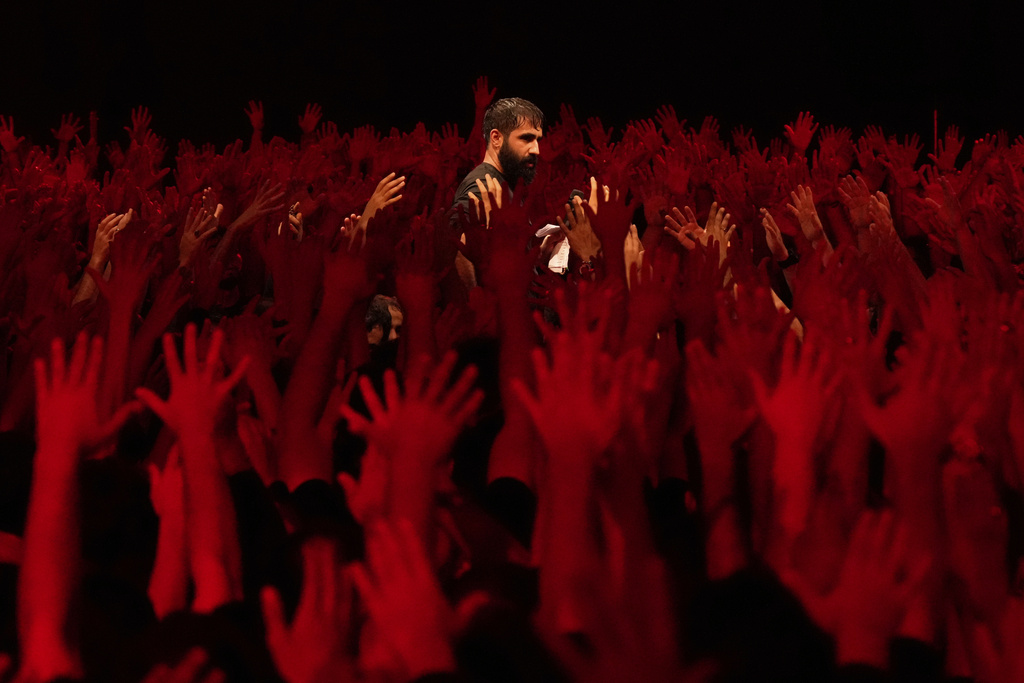 Iranian Shiite Muslims mourn in a ceremony in Tehran Iran, on Saturday, July 5, 2025, on the eve of Ashoura, the death anniversary of Prophet Muhammad's grandson, Hussein, who was killed with his 72 companions in a 7th-century battle in Karbala in present-day Iraq. (AP Photo/Vahid Salemi)
