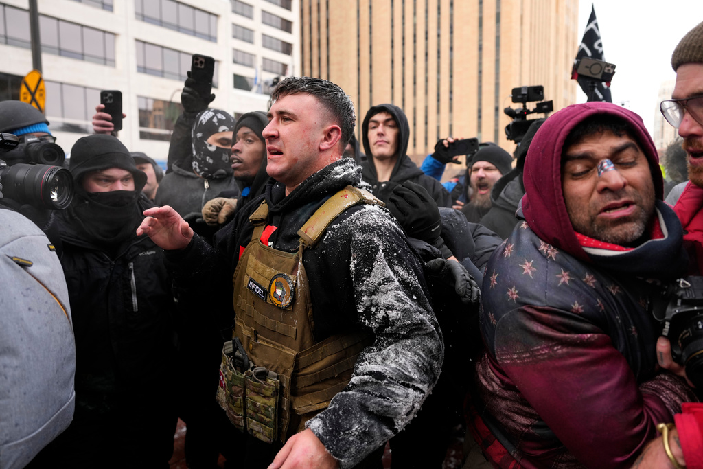 Jake Lang, center, who organized the March Against Minnesota Fraud, clashes with pro-immigration counterprotesters near Minneapolis City Hall, Saturday, Jan. 17, 2026, in Minneapolis. (AP Photo/Yuki Iwamura)