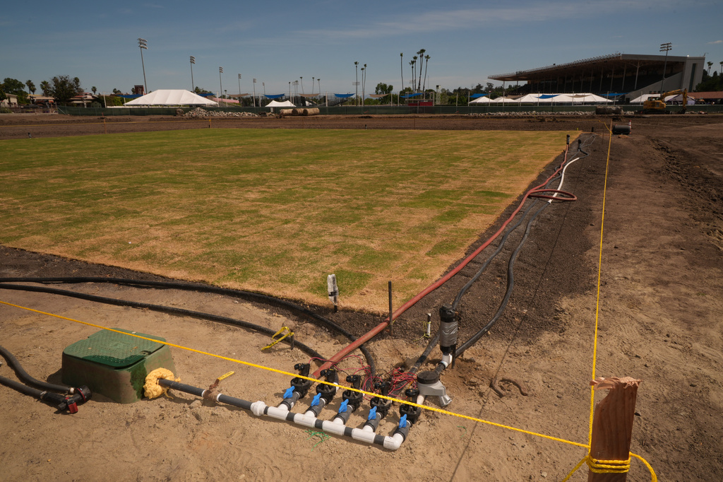 New fresh grass is grown for a world-class cricket pitch at the Pomona Fairplex on Wednesday, April 22, 2026, seen during the groundbreaking of the new Knight Riders Cricket Field, which will serve as the Los Angeles Knight Riders' official home field for 2026 and later host cricket at the LA 2028 Olympics. (AP Photo/Damian Dovarganes)