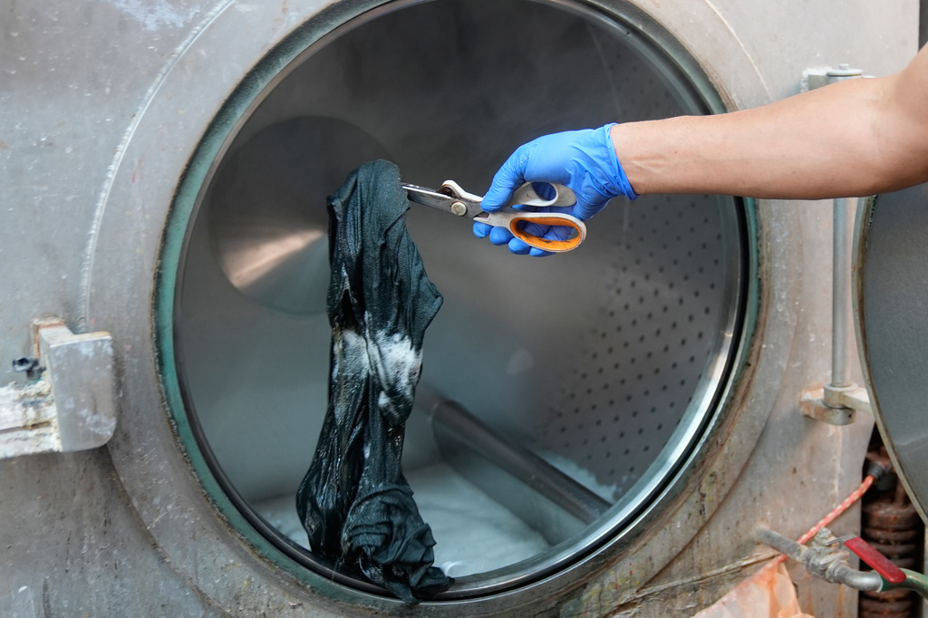 A piece of clothing is examined for color during a wash at the BPD Washhouse, a denim processing facility, in Jersey City, N.J., Tuesday, May 5, 2026. (AP Photo/Seth Wenig)