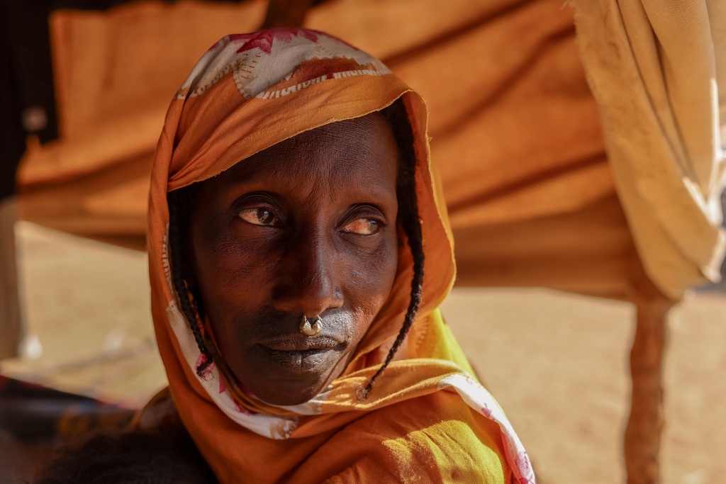 A Fulani woman who fled violence in Mali and found refuge in Fassala, Hodh El Chargui Region, Mauritania, sits in the camp, Nov. 9, 2025. (AP Photo/Caitlin Kelly)