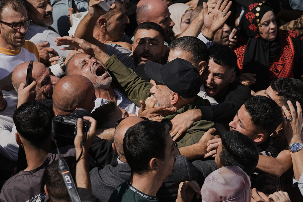Palestinian prisoners are greeted after being released from Israeli prison following a ceasefire agreement between Israel and Hamas, in the West Bank city of Ramallah, Monday, Oct. 13, 2025. (AP Photo/Mahmoud Illean)