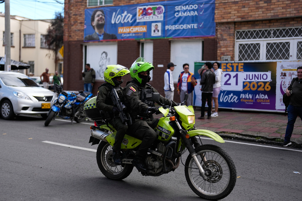 Police patrol past the headquarters of presidential candidate Ivan Cepeda, of the ruling Historic Pact coalition, in Bogota, Colombia, Tuesday, June 16, 2026. (AP Photo/Fernando Vergara)