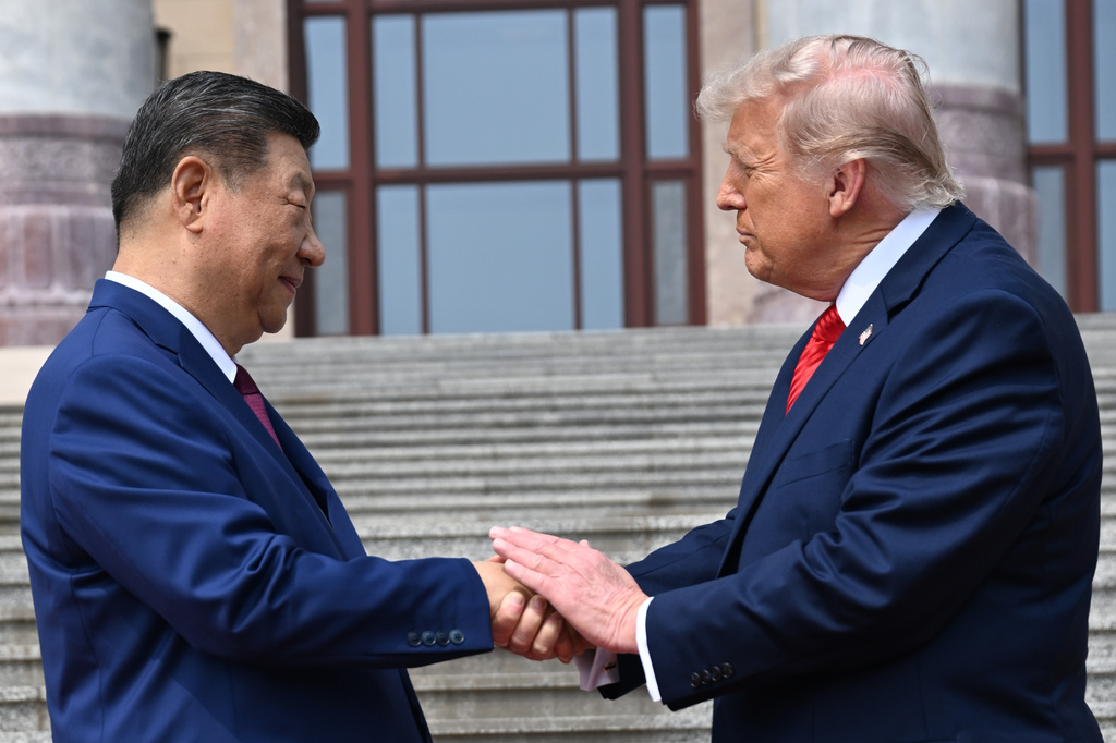 FILE - Chinese President Xi Jinping, left, shakes hands with President Donald Trump at the Great Hall of the People in Beijing, May 14, 2026. (Kenny Holston/Pool Photo via AP, file)