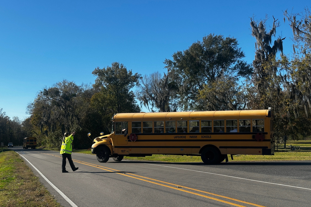 A school bus carries children at the end of a school day at Sixth Ward Middle School in Thibodaux, La., on Dec, 11, 2025. (AP Photo/Stephen Smith)