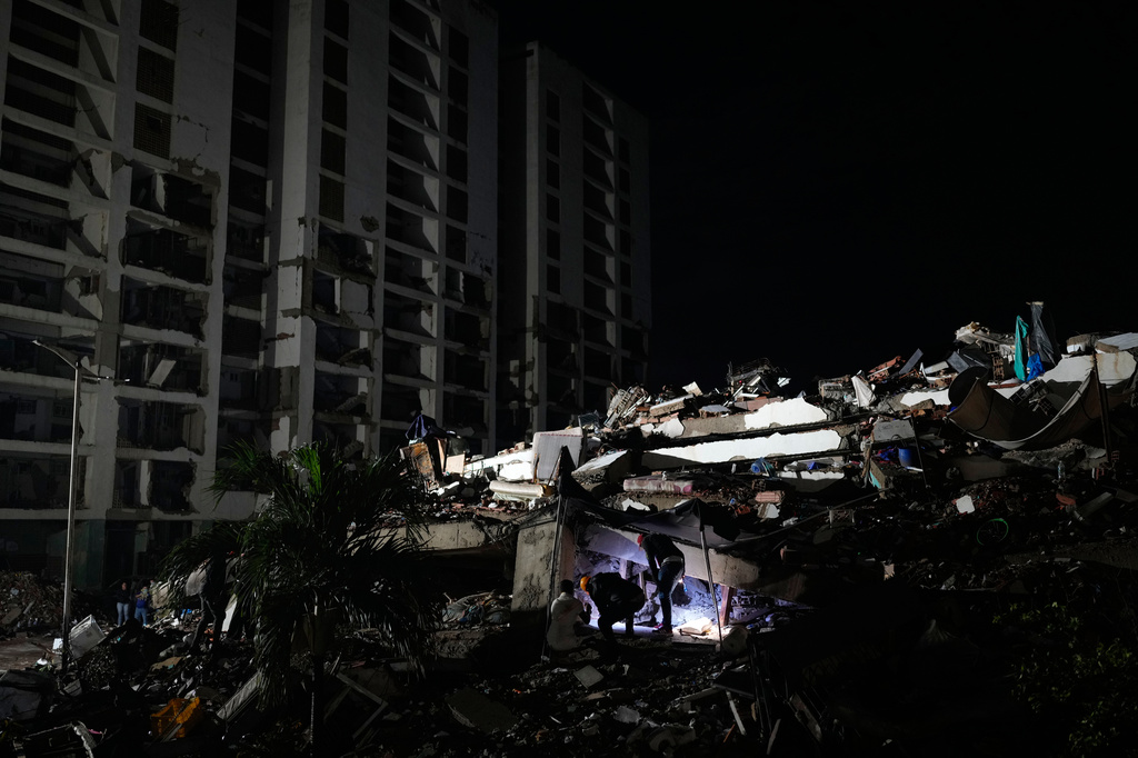Rescuers search through the rubble of a building that collapsed in the earthquakes in La Guaira, Venezuela, Tuesday, June 30, 2026. (AP Photo/Ariana Cubillos)