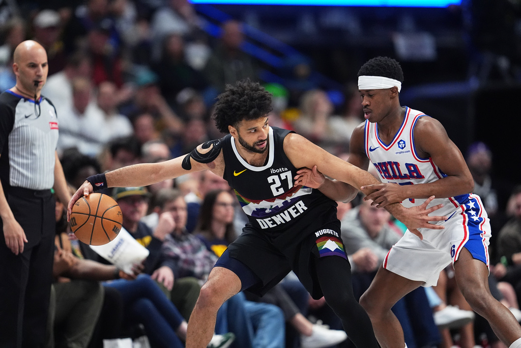 Denver Nuggets guard Jamal Murray, left, looks to drive to the net as Philadelphia 76ers guard Vj Edgecombe defends in the first half of an NBA basketball game, Tuesday, March 17, 2026, in Denver. (AP Photo/David Zalubowski)