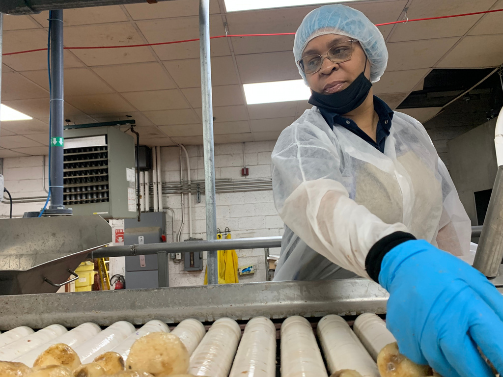 Better Made Snack Foods worker Tonya Tinsleydoes quality control checks on potatoes at a processing facility in Detroit, on Thursday, April 2, 2026 (AP Photo/Mike Householder)
