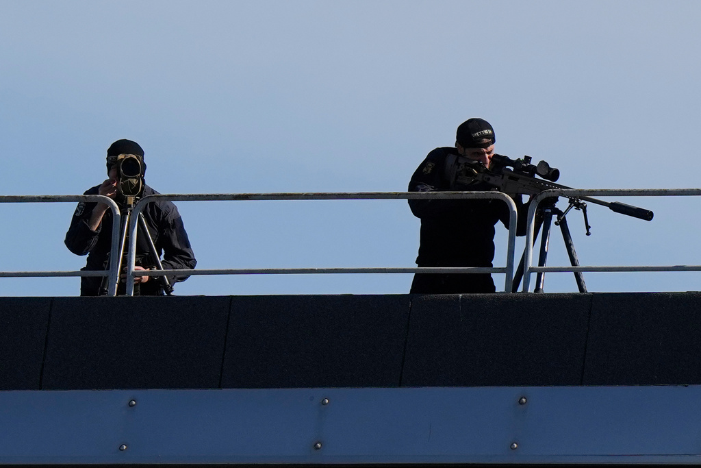 Snipers patrol on the roof of the Fruili Hotel where the Israeli national team is staying, ahead of a World Cup 2026, Group I qualifying soccer match between Italy and Israel at the Friuli Stadium in Udine, Italy, Tuesday, Oct.14, 2025. (AP Photo/Luca Bruno)