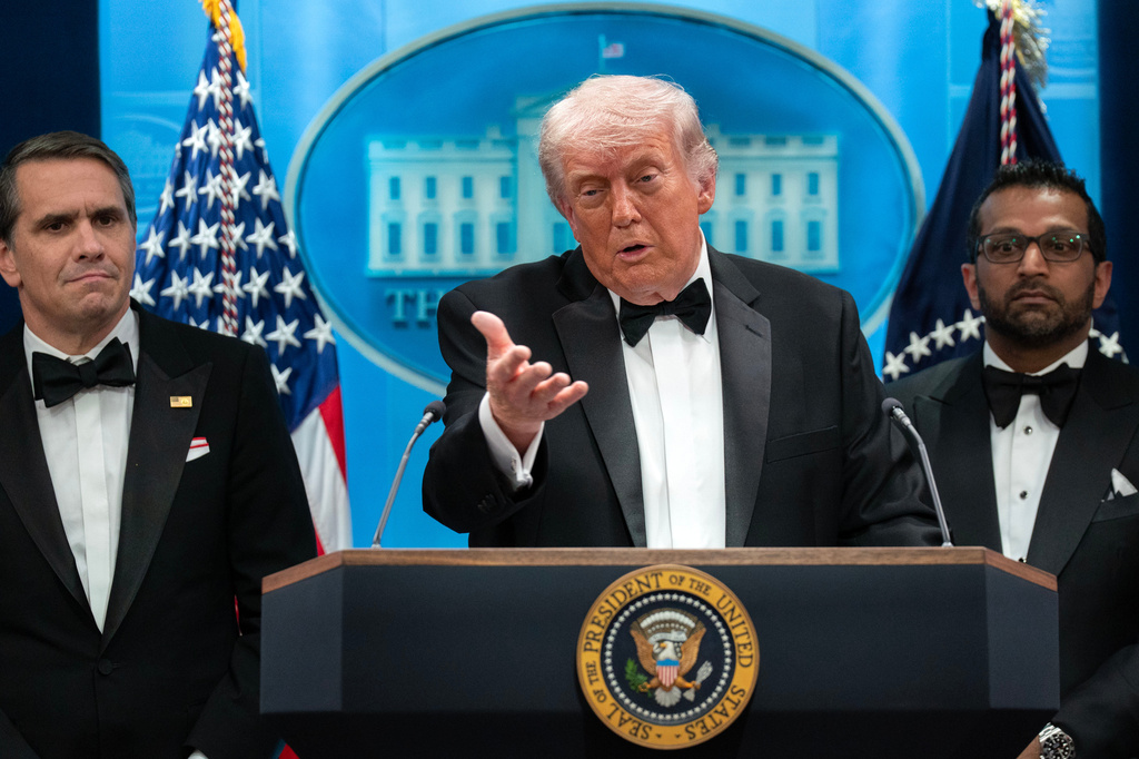 FILE - President Donald Trump speaks in the James Brady Press Briefing Room at the White House after a shooting incident outside the ballroom at at the annual White House Correspondents' Association dinner in Washington, April 25, 2026, as acting Attorney General Todd Blanche, left, and FBI director Kash Patel listen. (AP Photo/Jose Luis Magana, File)