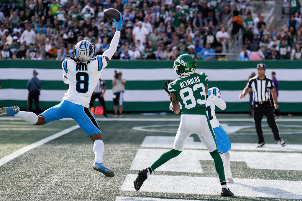Carolina Panthers cornerback Jaycee Horn (8) intercepts a pass intended for New York Jets wide receiver Josh Reynolds (83) during the third quarter of an NFL football game, Sunday, Oct. 19, 2025, in East Rutherford, N.J. (AP Photo/Seth Wenig)