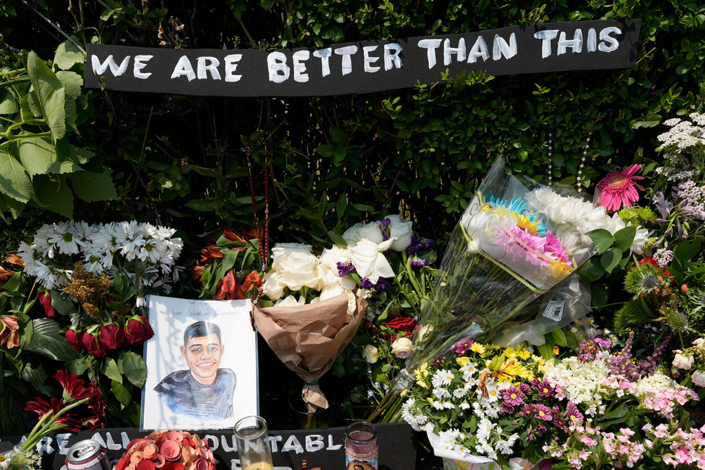A portrait of Johan Sebastián Durán Guerrero, the man killed by U.S. Immigration and Customs Enforcement, is displayed among flowers and tributes at a makeshift memorial in Biddeford, Maine, Wednesday, July 15 2026. (AP Photo/Robert F. Bukaty)
