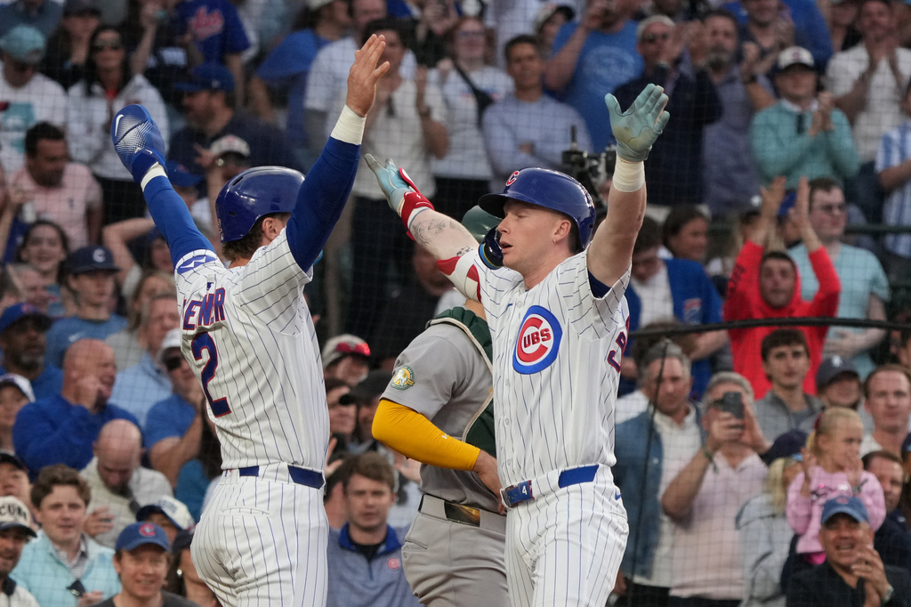 Chicago Cubs' Pete Crow-Armstrong, right, is greeted by Nico Hoerner, left after hitting a two-run home run against the Athletics during the third inning in a baseball game Wednesday, June 3, 2026, in Chicago. (AP Photo/David Banks)