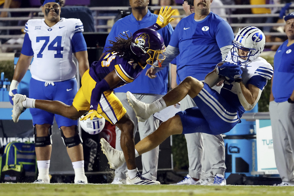 BYU wide receiver Chase Roberts, right, attempts to catch the ball in front of East Carolina's TyMir Brown (24) but is out of bounds during the first half of an NCAA college football game in Greenville, N.C., Saturday, Sept. 20, 2025. (AP Photo/Karl DeBlaker)