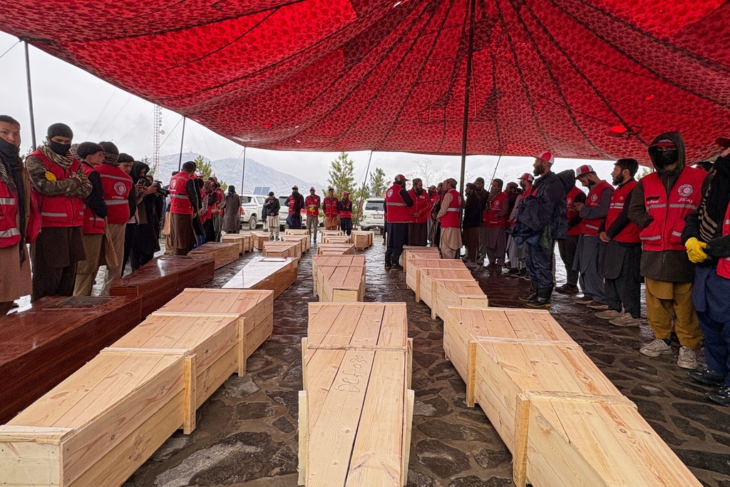 Coffins containing the remains of victims of a Monday airstrike on a drug rehabilitation hospital are laid out before burial in Kabul, Afghanistan, Wednesday, March 18, 2026. (AP Photo/Siddiqullah Alizai)